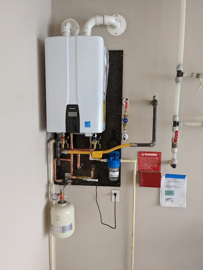 Professional plumber installing copper piping in a Maywood home